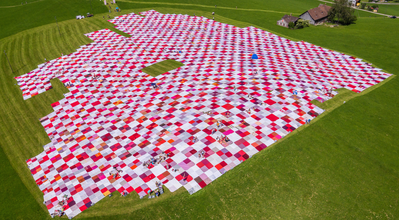 Illustration for article titled The World's Biggest Picnic Blanket Is Growing in the Swiss Countryside